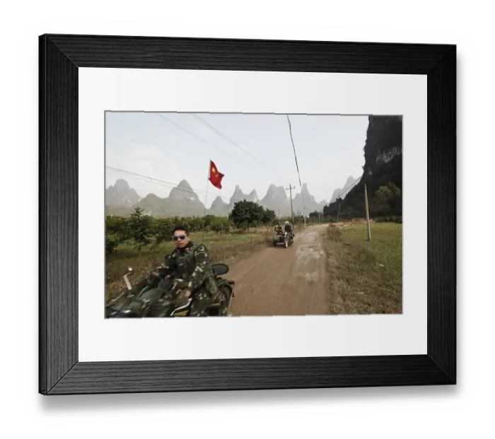 Framed Print : Motorcyclist in front of karst mountains in Yangshuo Framed Print : Motorcyclist in front of karst mountains in Yangshuo
