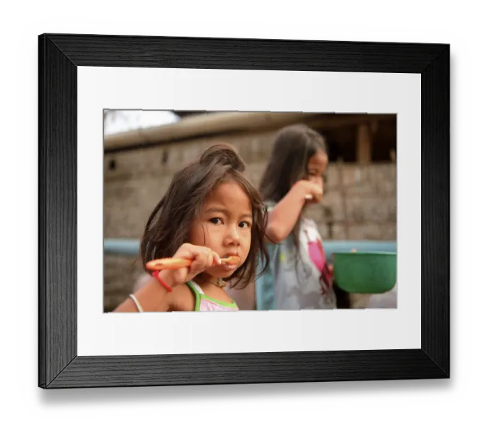 Framed Print : Two girls brushing their teeth outside a house Framed Print : Two girls brushing their teeth outside a house