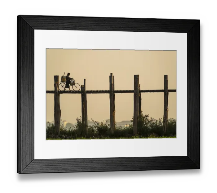 Framed Print : Man with a bike walking on a teak bridge