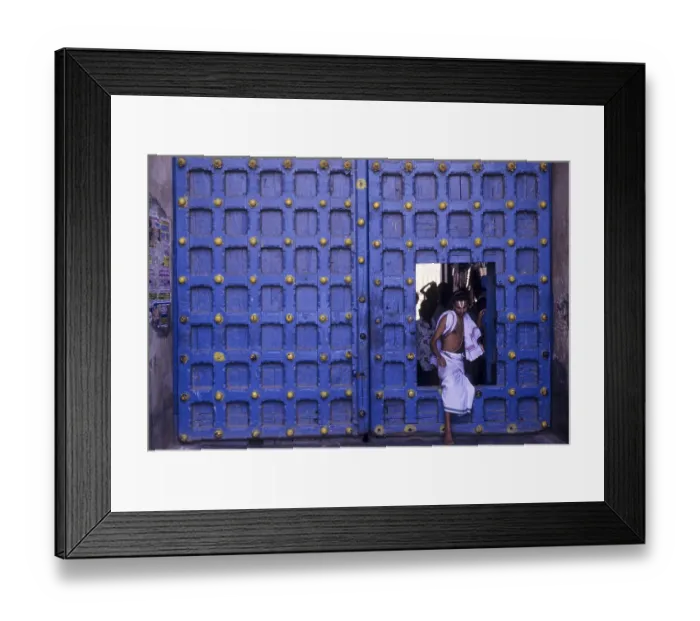 Framed Print : Temple priest crossing the Main door in Varadarajaswamy temple
