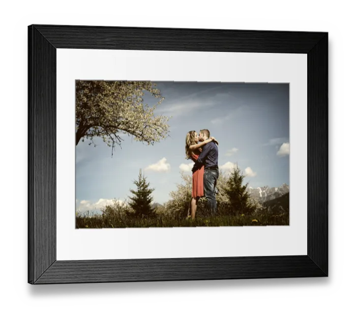 Framed Print : Lovers kissing next to a flowering tree in the spring