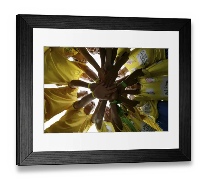 Framed Print : Soccer team motivating themselves in a circle before a game Framed Print : Soccer team motivating themselves in a circle before a game