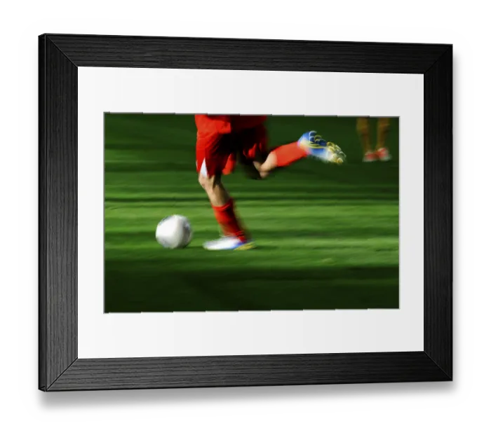 Framed Print : A football player's legs with a football Framed Print : A football player's legs with a football