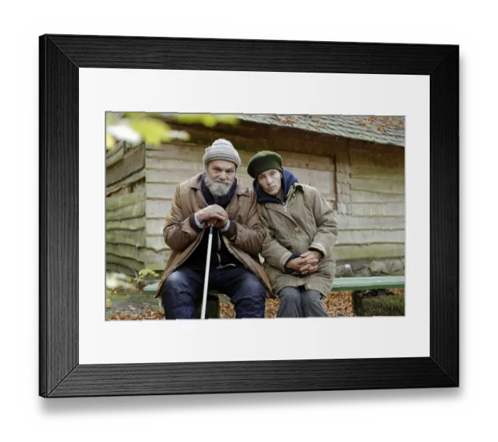 Framed Print : Homeless couple in front of a forest hut