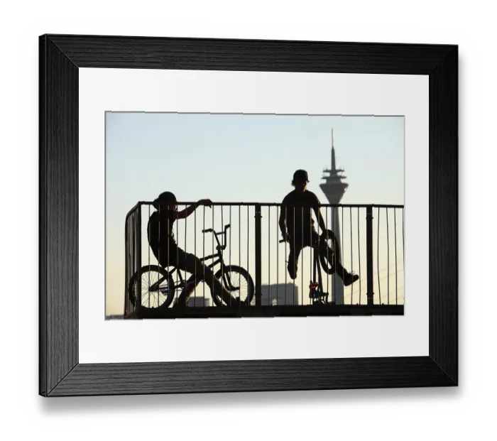 Framed Print : Teenagers with BMX bikes at a halfpipe on the Rhine