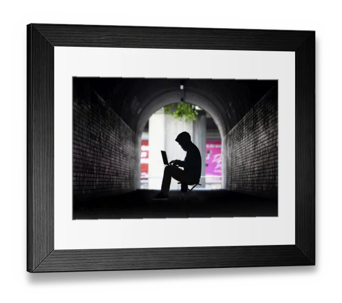 Framed Print : Man surfing on a laptop computer in a pedestrian tunnel Framed Print : Man surfing on a laptop computer in a pedestrian tunnel