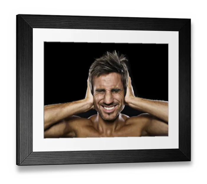 Framed Print : Young man holding his hands against his ears Framed Print : Young man holding his hands against his ears