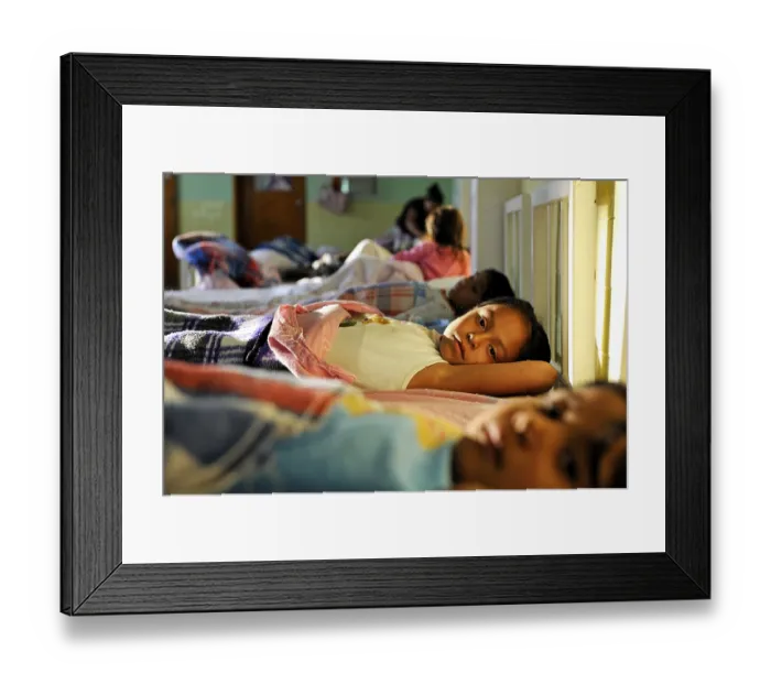 Framed Print : Girls going to sleep in the dormitory of an orphanage