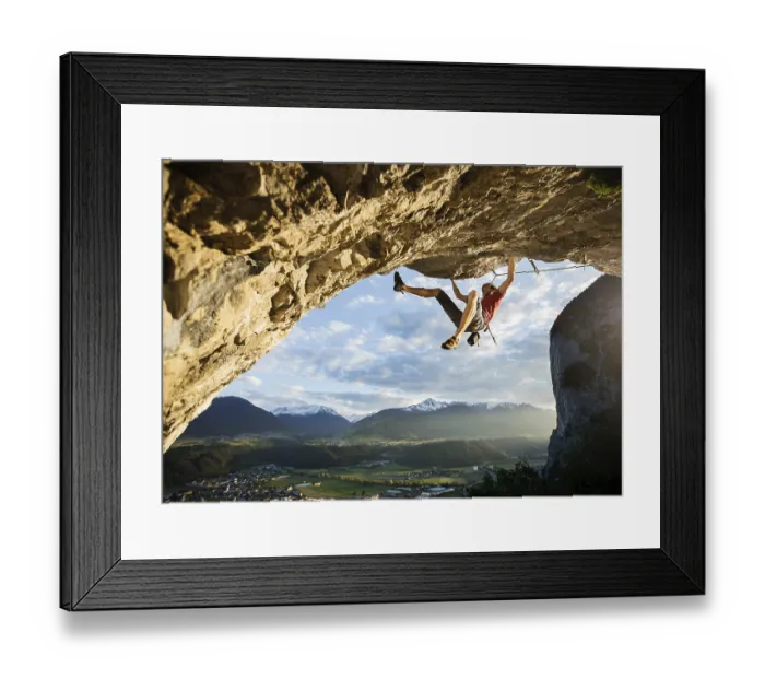Framed Print : Freeclimber with helmet climbing on a rock face
