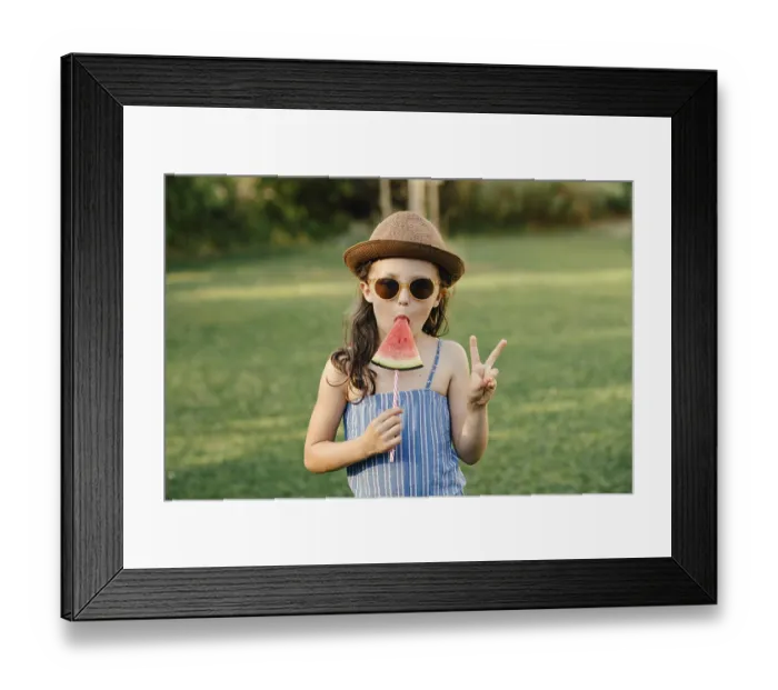 Framed Print : Girl eats watermelon on a stick