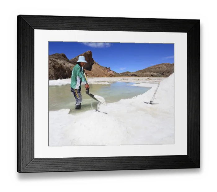 Framed Print : Young man, worker shovels salt