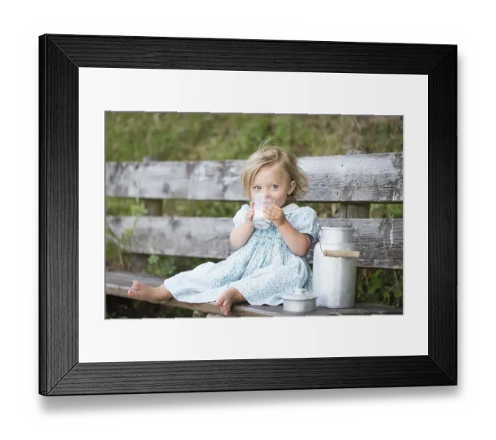 Framed Print : Girl drinking milk on a bench at an Alpine hut