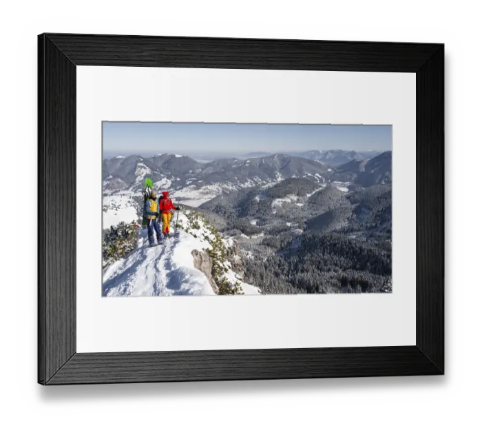 Framed Print : Young woman and man on ski tour