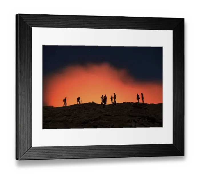 Framed Print : Tourists at the crater rim of the volcano Erta Ale in front of a red glowing steam cloud