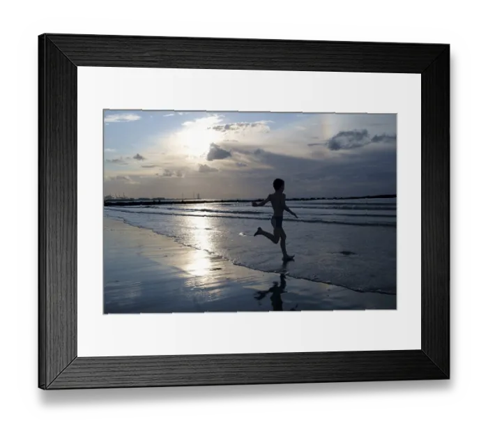 Framed Print : Child walks into the sea, backlit, Germany Framed Print : Child walks into the sea, backlit, Germany