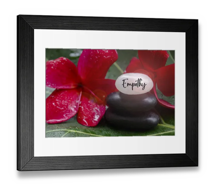 Framed Print : Empathy text engraved on white zen stones with zen flower background