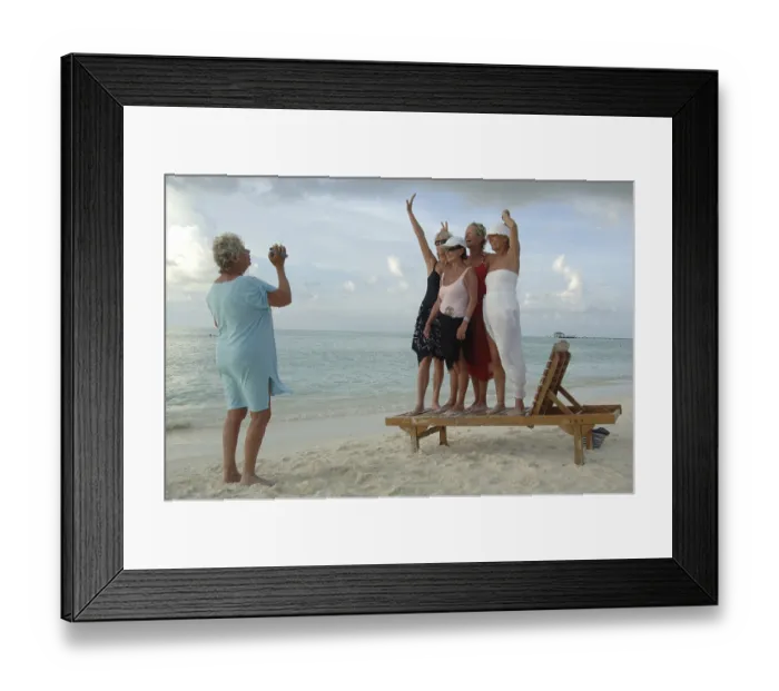 Framed Print : Elderly women filming each other with a video camera on the beach