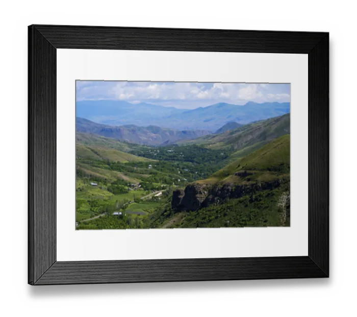 Framed Print : Extensive valley surrounded by green mountains