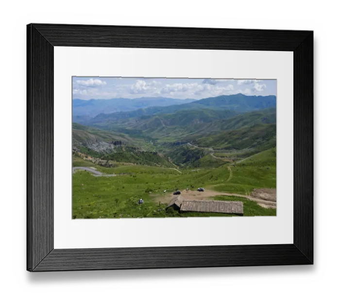 Framed Print : Mountains with isolated vehicles in a meadow Framed Print : Mountains with isolated vehicles in a meadow