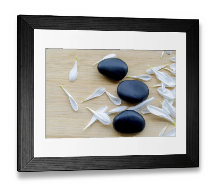 Framed Print : Top view of Close up view of fresh white flower next to stacked black stones natural balance with customizable space