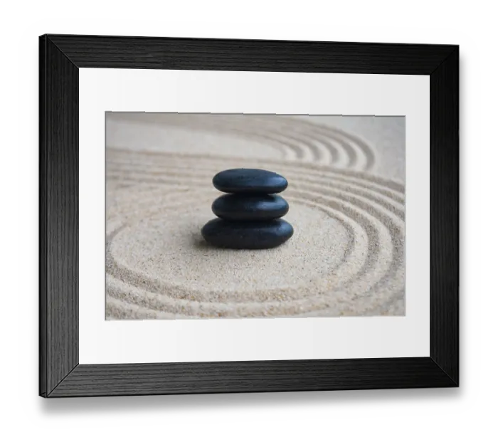 Framed Print : Black zen stones inside lines carved on sand with customizable space for text Framed Print : Black zen stones inside lines carved on sand with customizable space for text