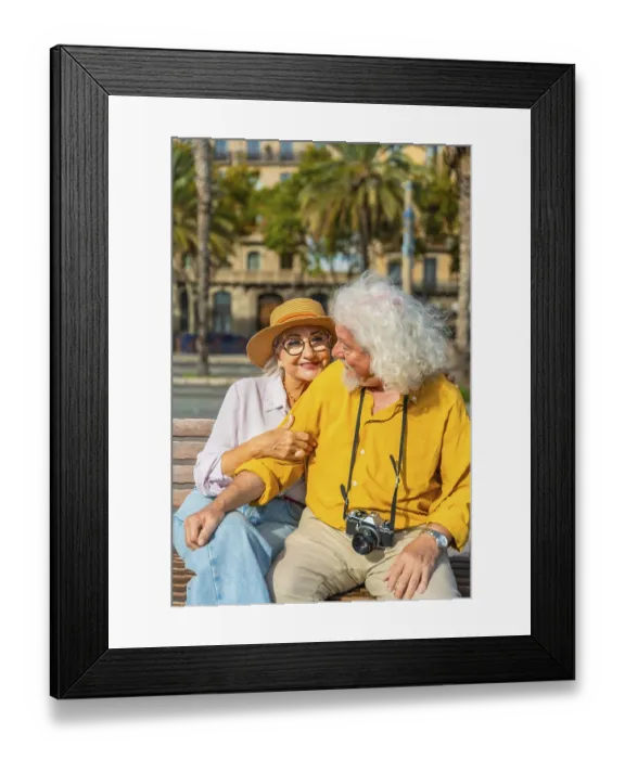Framed Print : Smiling senior woman embracing her husband on a bench
