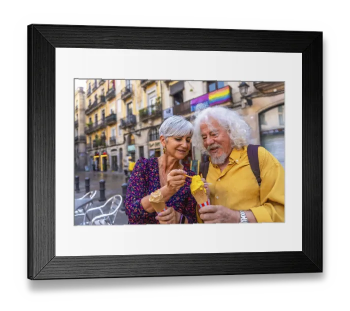 Framed Print : Happy senior couple sharing ice cream while sightseeing in a european city