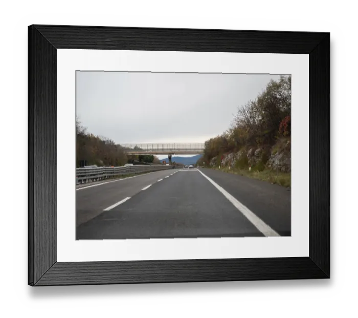 Framed Print : Highway leading to a bridge with trees and mountains in the background Framed Print : Highway leading to a bridge with trees and mountains in the background