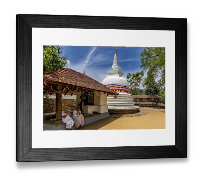 Framed Print : People pray in front of temples and white stupa under a blue sky