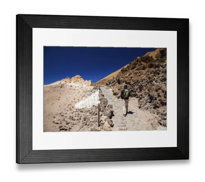 Framed Print : Tourist man with backpack going to the top of the volcano Teide in Tenerife Framed Print : Tourist man with backpack going to the top of the volcano Teide in Tenerife
