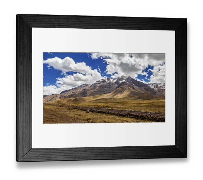 Framed Print : Impressive mountain range with snowy peaks under a cloudy blue sky