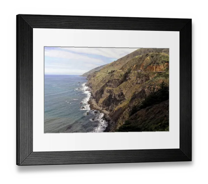Framed Print : Rugged coastline with high cliffs and distant mountains Framed Print : Rugged coastline with high cliffs and distant mountains