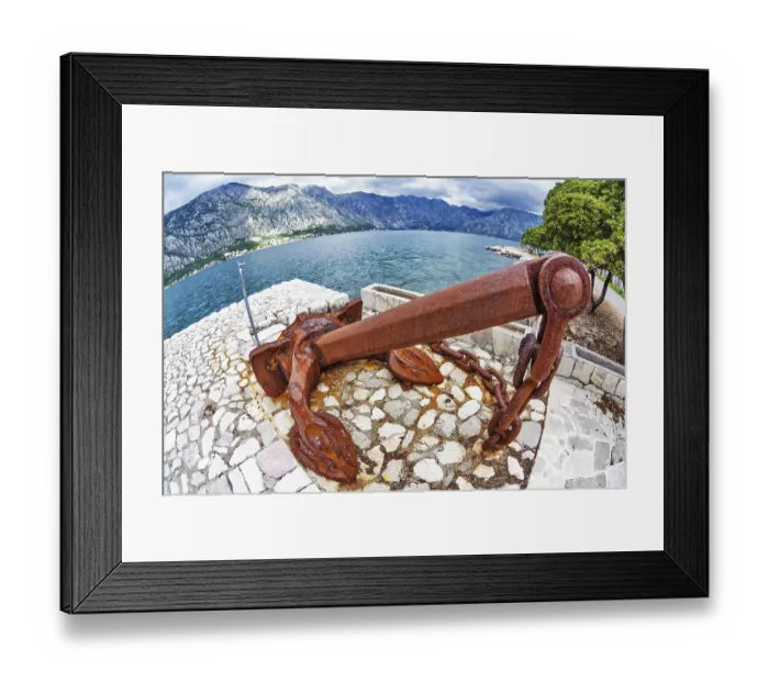 Framed Print : Old anchor on the waterfront on mountains background Framed Print : Old anchor on the waterfront on mountains background