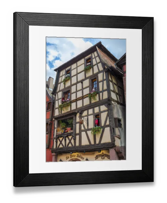 Framed Print : Timber-frame house decorated with vehicles in the historic old town of Riquewihr