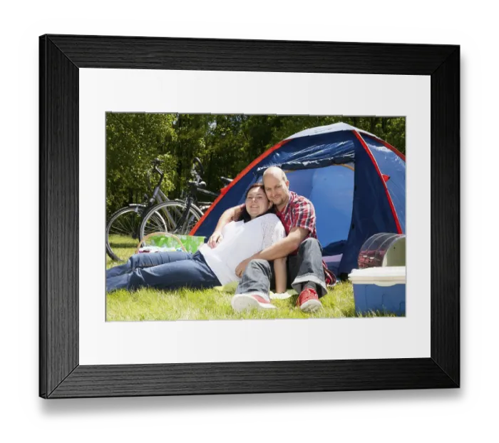 Framed Print : Happy young couple is relaxing on a camping Framed Print : Happy young couple is relaxing on a camping