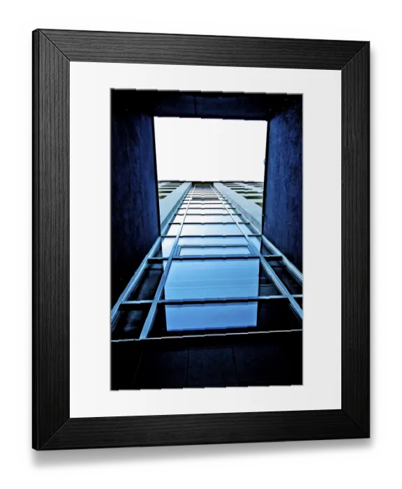 Framed Print : View looking up at a modern building with blue glass and strong vertical lines Framed Print : View looking up at a modern building with blue glass and strong vertical lines