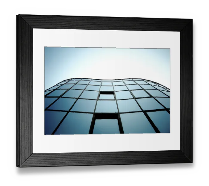 Framed Print : Modern glass building with blue sky reflection creating a geometric urban aesthetic Framed Print : Modern glass building with blue sky reflection creating a geometric urban aesthetic