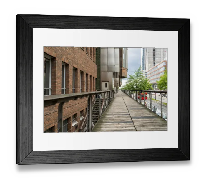 Framed Print : Wooden pedestrian walkway surrounded by modern and historic architecture in Hamburg Framed Print : Wooden pedestrian walkway surrounded by modern and historic architecture in Hamburg