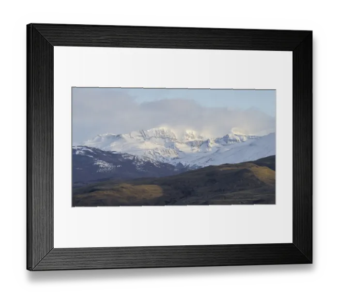 Framed Print : Sunlit snowy mountains with clear sky and distant ridges in the background Framed Print : Sunlit snowy mountains with clear sky and distant ridges in the background