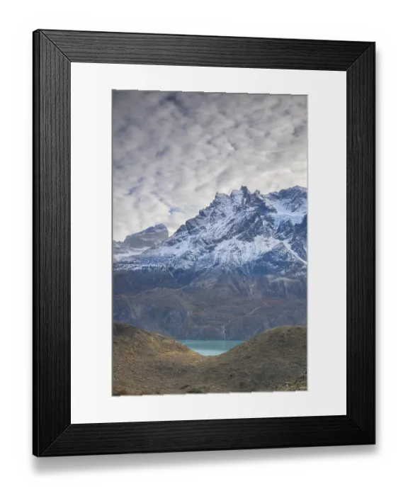Framed Print : Towering snowy mountains beneath a moody