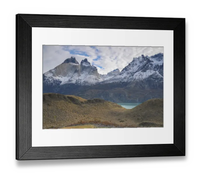 Framed Print : Wide view of snowy mountains and a lake under a bright Framed Print : Wide view of snowy mountains and a lake under a bright