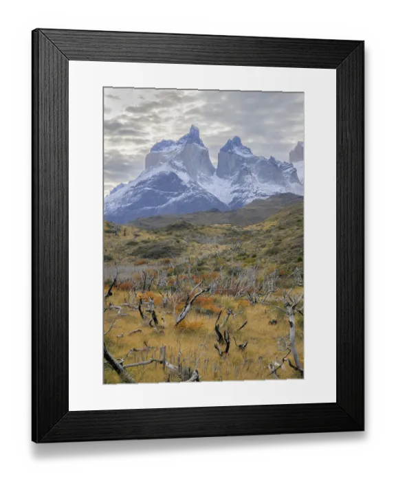 Framed Print : Snow-dusted mountains rise above a rugged