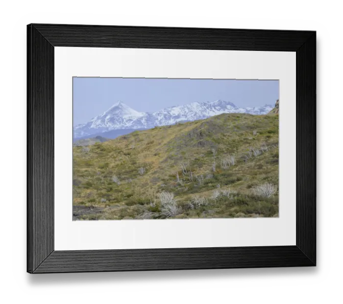 Framed Print : Snow-capped mountains with rocky terrain and sparse grass create a serene landscape Framed Print : Snow-capped mountains with rocky terrain and sparse grass create a serene landscape