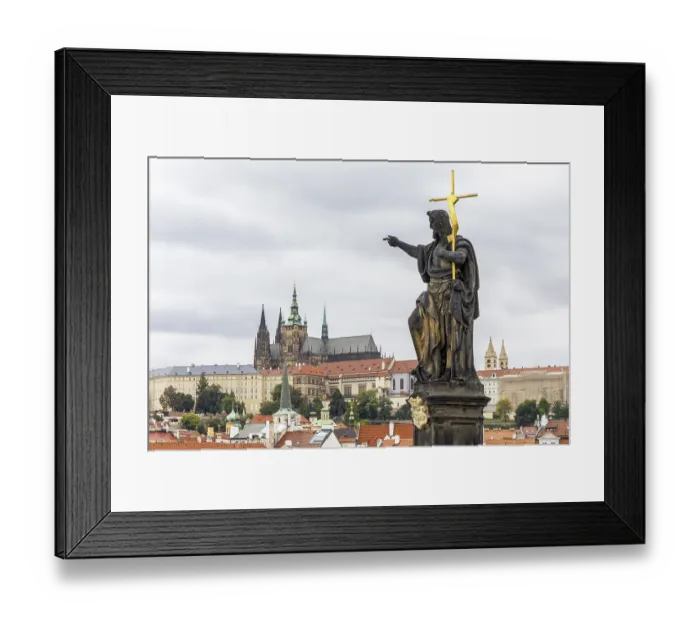 Framed Print : Baroque sculpture group Saint John the Baptist on historically mean Charles Bridge in Gothic style across the Vltava Framed Print : Baroque sculpture group Saint John the Baptist on historically mean Charles Bridge in Gothic style across the Vltava