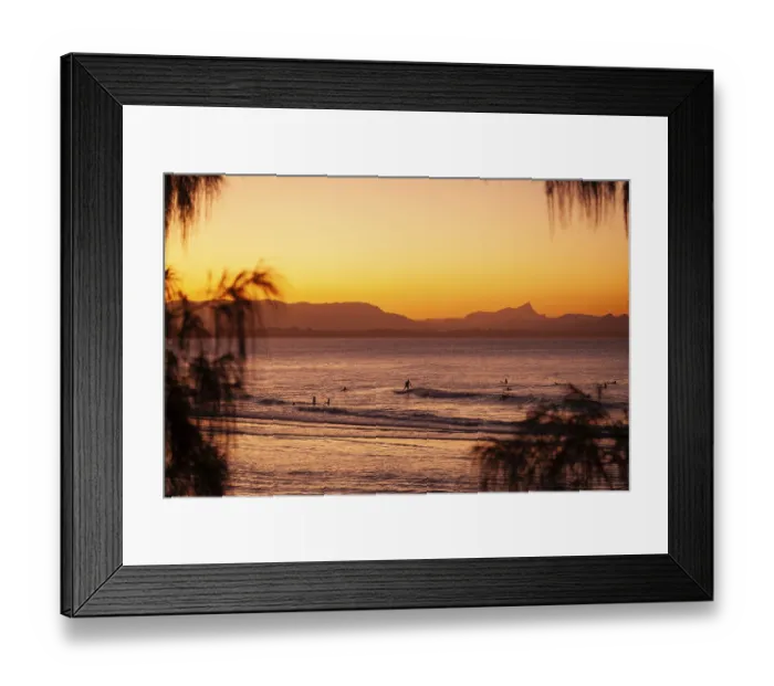 Framed Print : View of the ocean and Wategos Beach on the promenade at sunset