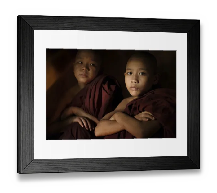 Framed Print : Young buddhist novice monk inside a temple background