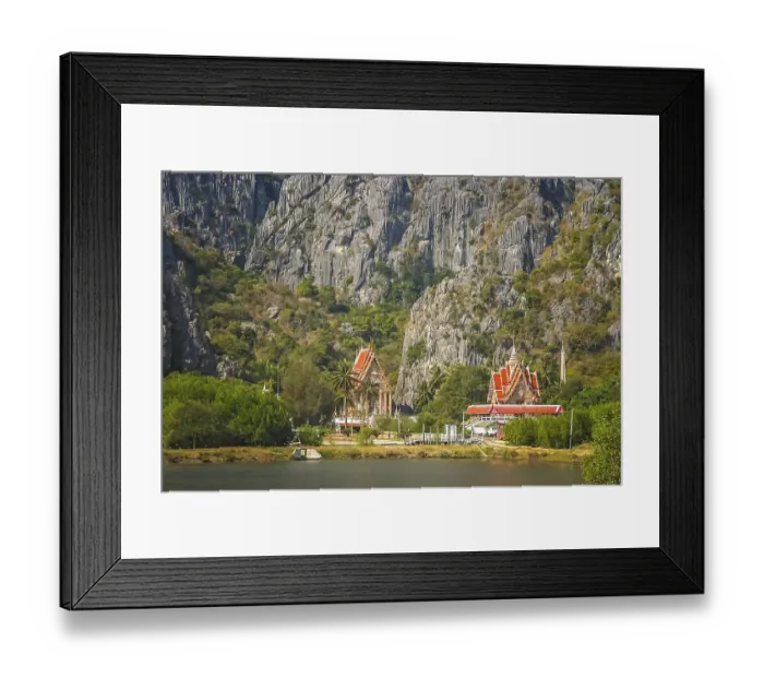 Framed Print : View of the Buddhist temples at the foot of rocky mountains on the lakeshore in thai countryside