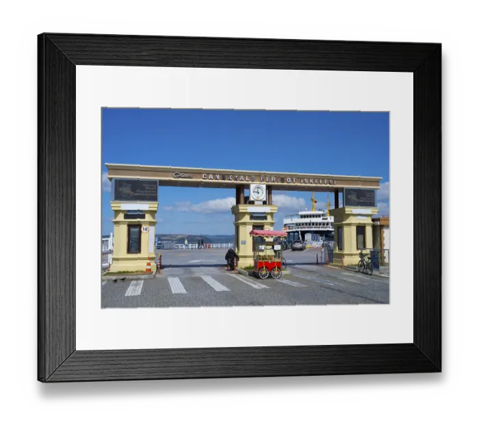 Framed Print : The entrance to the ferry terminal with clock and a kiosk in sunny weather
