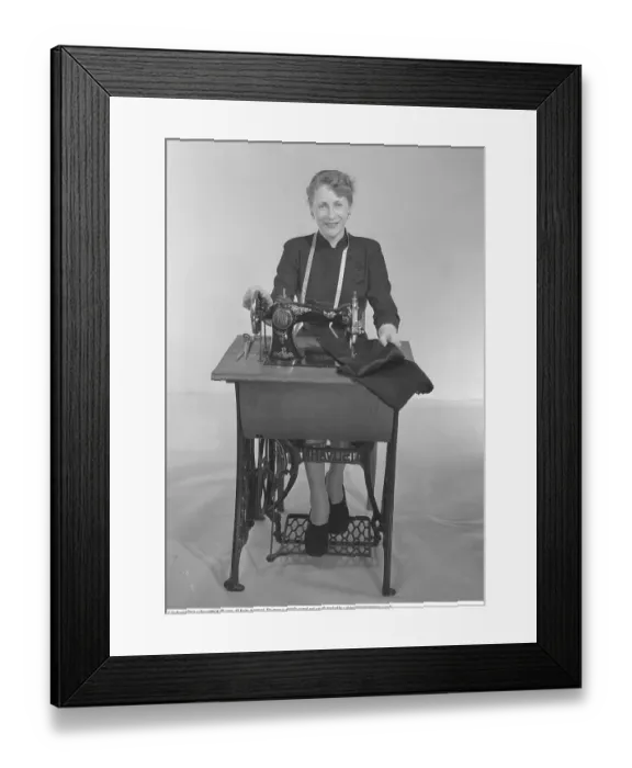 Framed Print : Sewing in the 1950s. The seamstress Mrs Jonsson at a Husqvarna sewing machine
