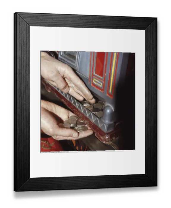 Framed Print : At the slot machine 1972. A person pictured at slot machine